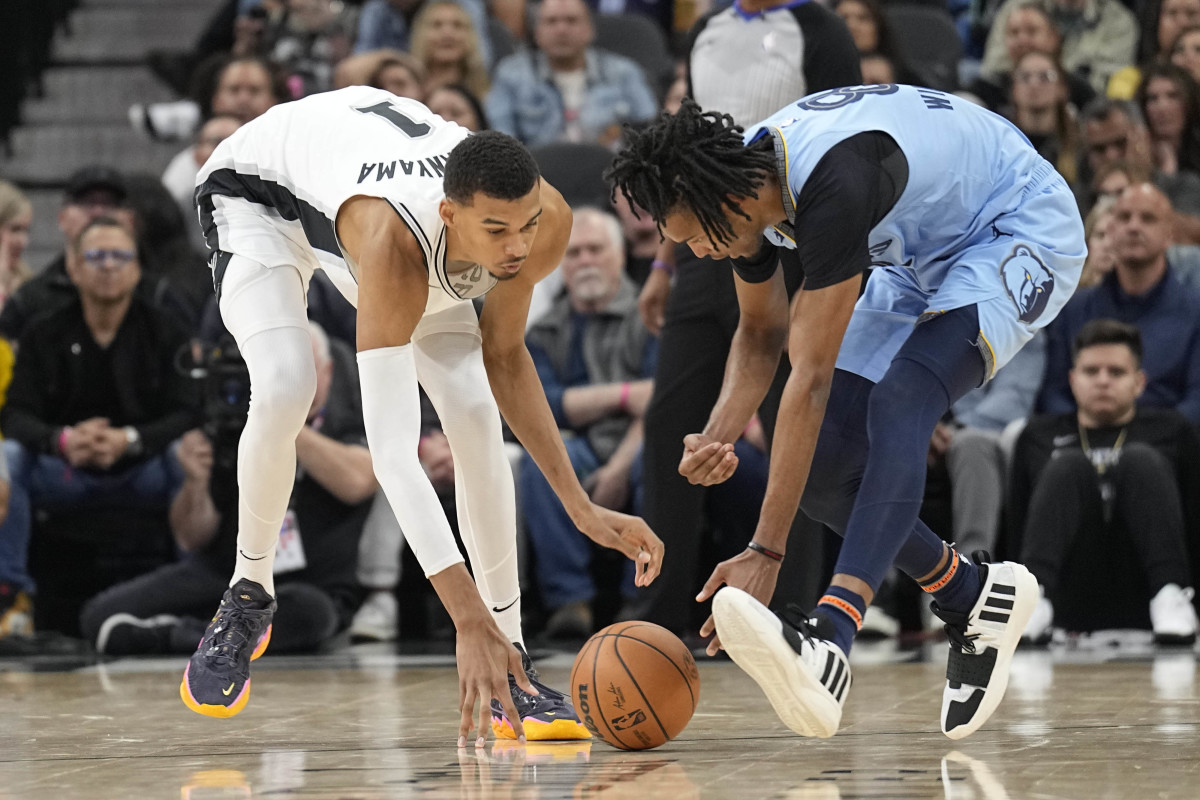 Nov 18, 2023; San Antonio, Texas, USA; Memphis Grizzlies forward Ziaire Williams (8) and San Antonio Spurs forward Victor Wembanyama (1) battle for a loose ball during the second half at Frost Bank Center.